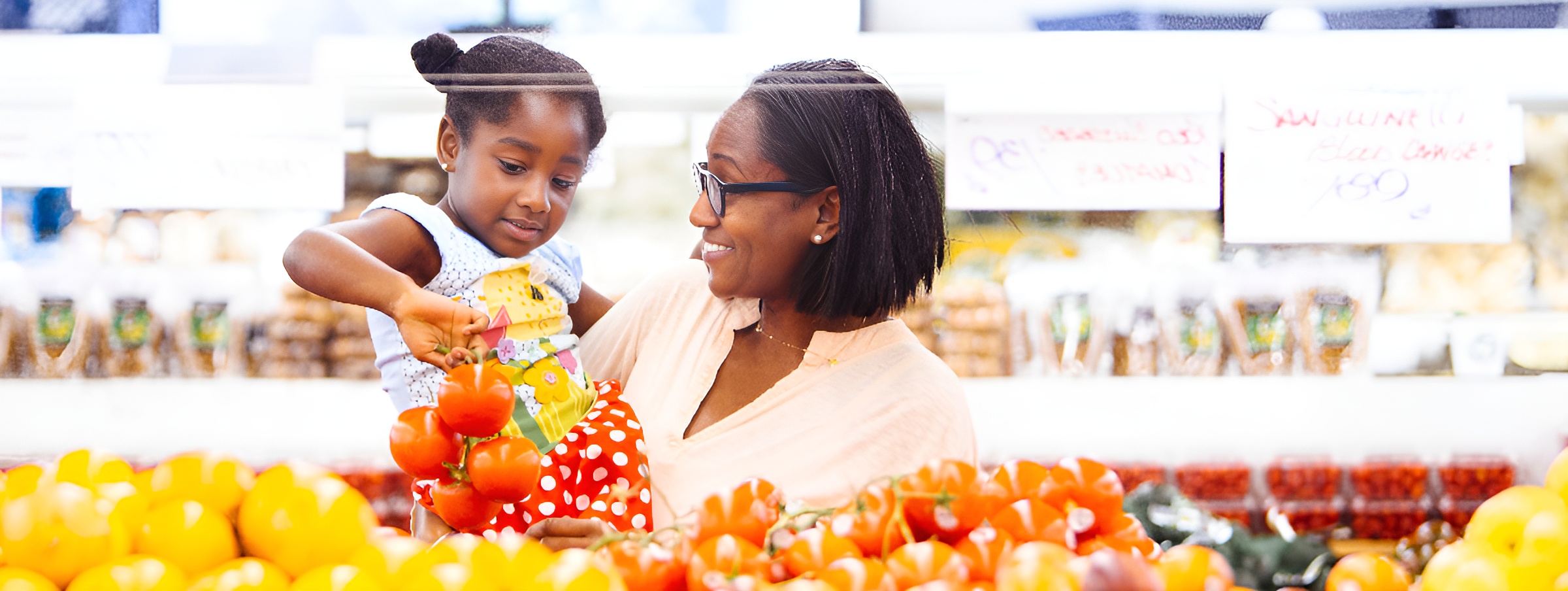 Woman grocery shopping with her children